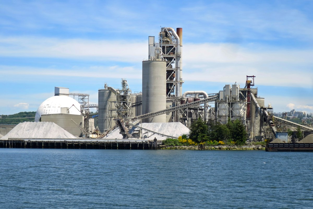 Reference photo: a cement plant beside the Duwamish River in Seattle, United States; not a Dangote Cement facility.