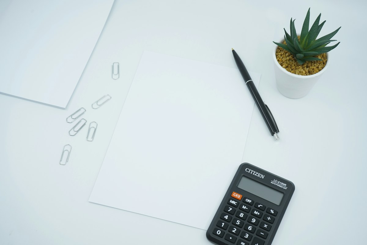 Reference photo: a calculator, pen and blank financial paperwork; not an FMDA report or current market data.