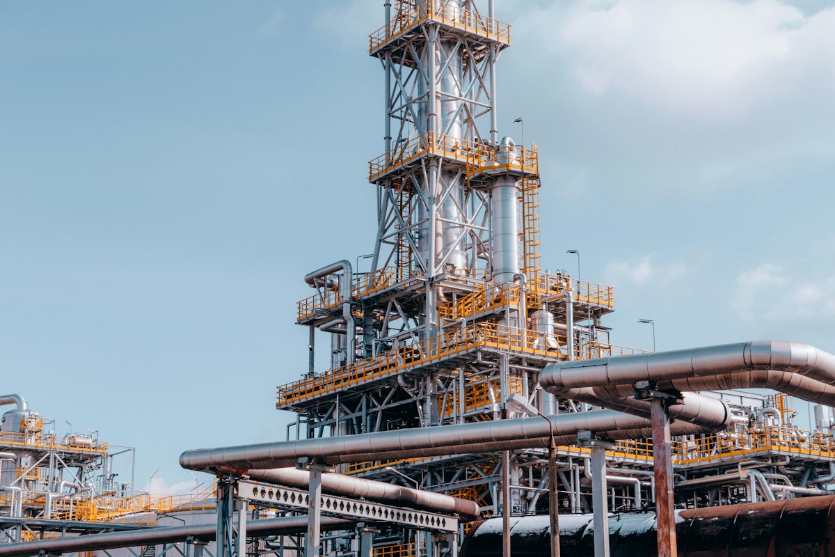 Reference photo: refinery pipes and towers in Trzebinia, Poland; not the Dangote refinery or Honeywell's AI launch.