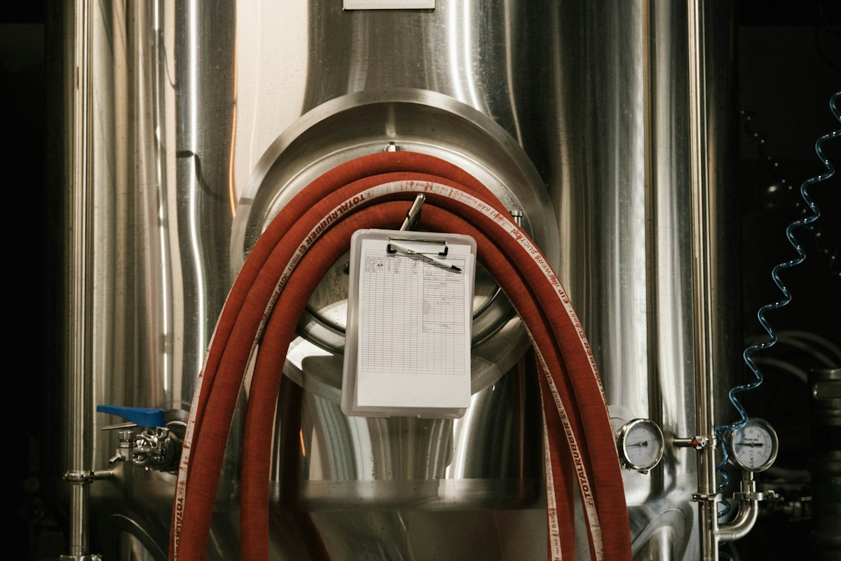 Reference photo: stainless-steel brewery fermentation tanks; not a photograph of International Breweries or its reported results.