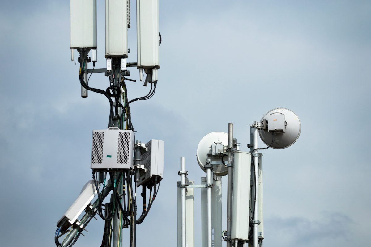 Reference photo: telecommunications towers and antennas beneath a cloudy sky; not a photograph of the NCC tariff announcement.