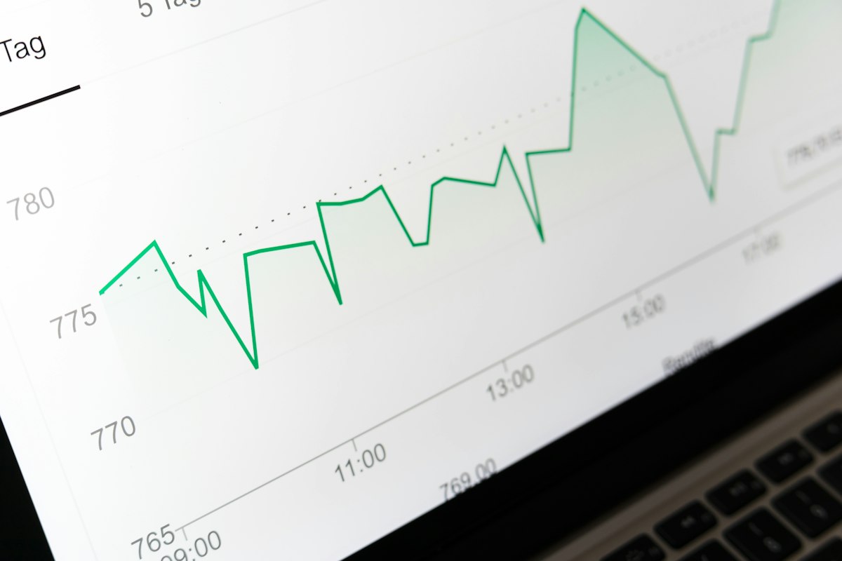 Reference photo: a share-price chart displayed on a laptop; figures are illustrative and are not live quotes or United Capital's results.